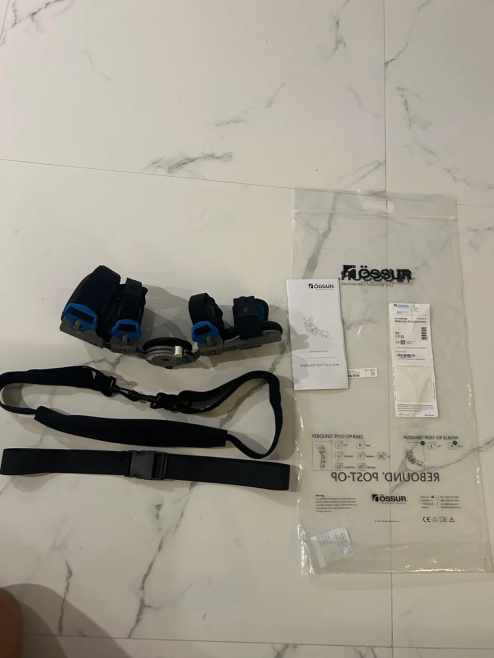 Össur Rebound Post-Op Elbow Brace Adjustable Black Gray Blue, right hand.